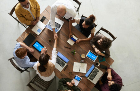 Top down view of a team sitting at a table